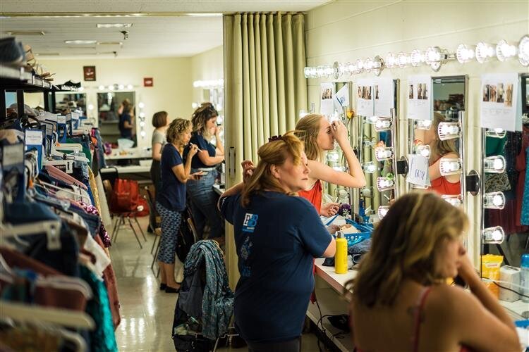 Backstage getting ready in wardrobe and makeup.