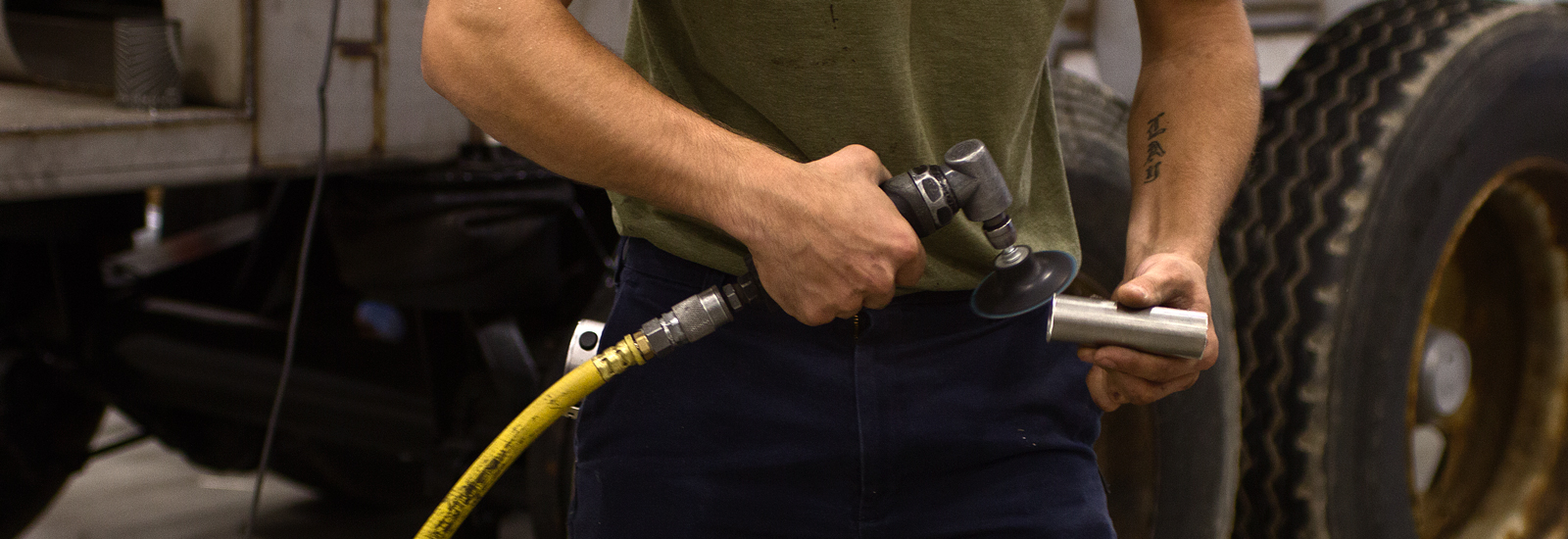 An employee at Burch Tank & Truck uses a grinder