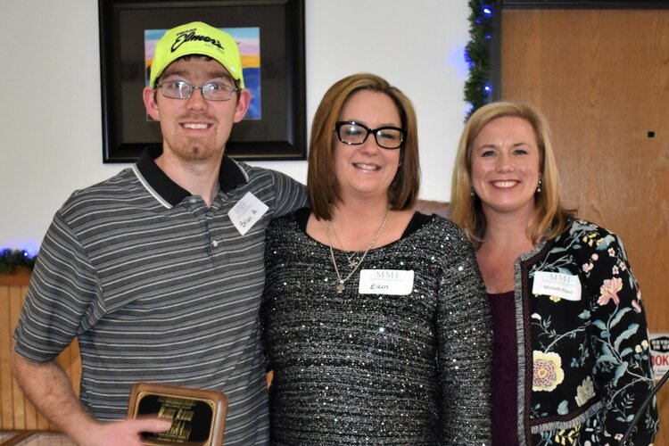 Brian Adam (left) accepts the McCollum-McFarlane Achievement Award for his work with MMI. 