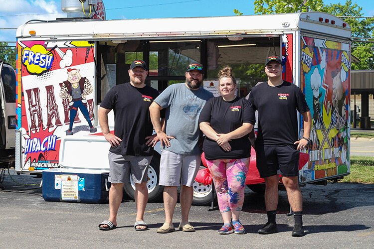 Co-owners of NOM NOM Ninja Brandon Haught (left) and Joe Collin (second from left) pose for a photo with Mark Craig (right) and Alicia Fancett.