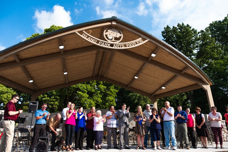 Community leaders celebrate the ribbon cutting of the new Island Park Arts Pavilion on Aug. 5.