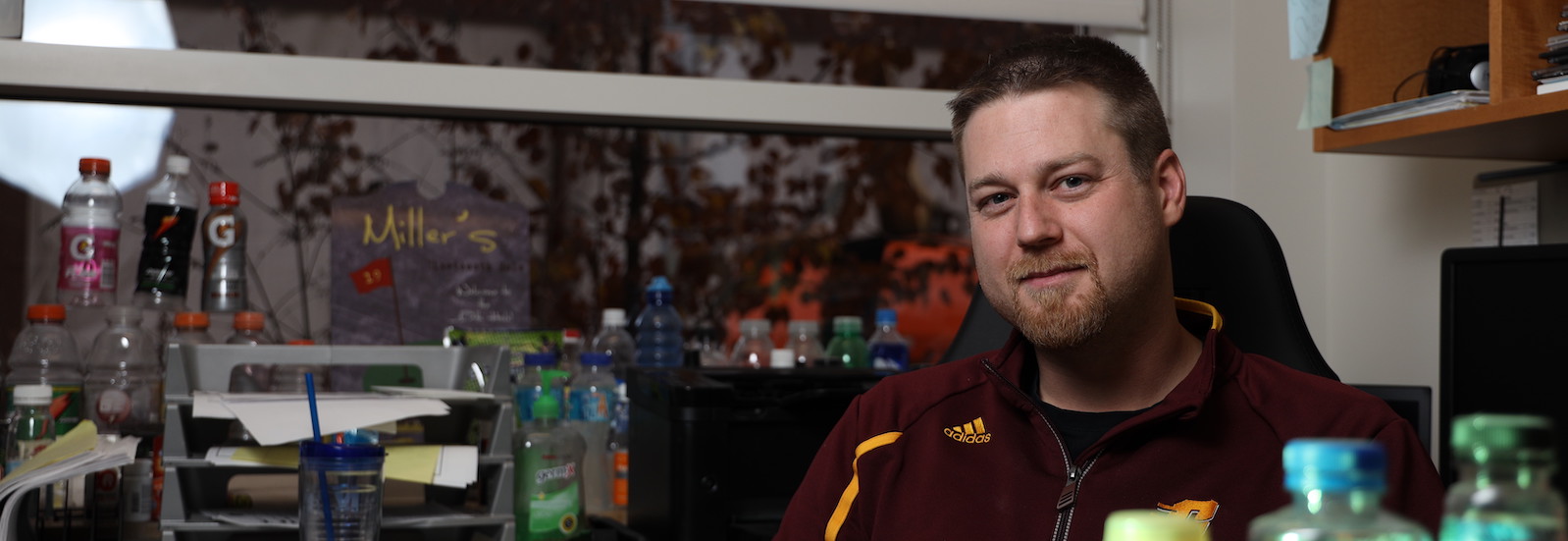 Dr. Kevin Miller surrounded by commercial sports drinks in his office