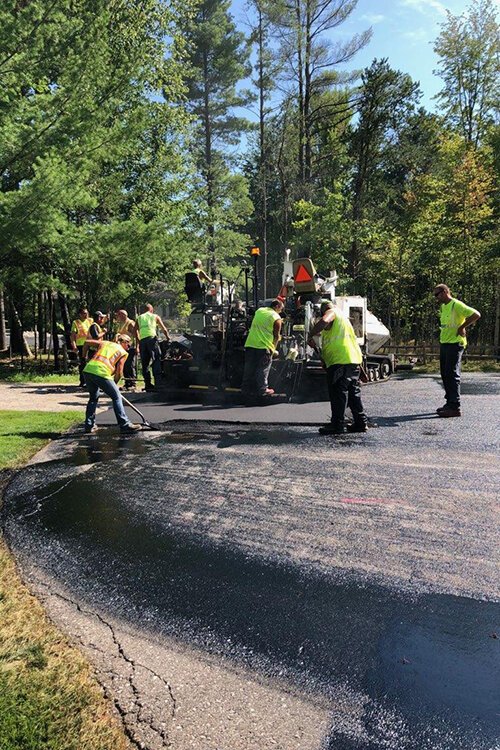 Central Asphalt’s paving crew placing the modified asphalt mix containing recycled plastic over Waskevich Lane in Larkin Township.