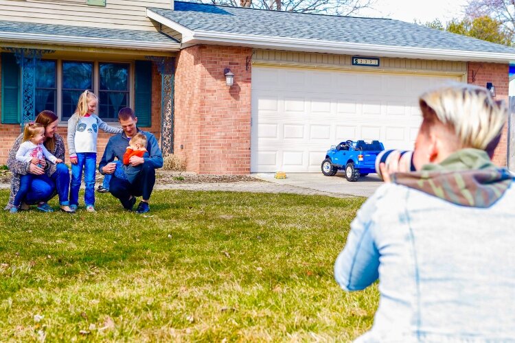 Photographer Ashley Brown stands 10 to 15 feet away from the people featured in her Porch Portraits Project.