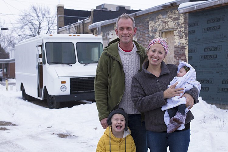 The owners of Roz's Diner, Chris and Megan Bair, pose for a photo with their two children, 3-year-old Roman and 2-month-old Margot, in front of the 1995 Chevrolet Grumman they are converting into a food truck. 