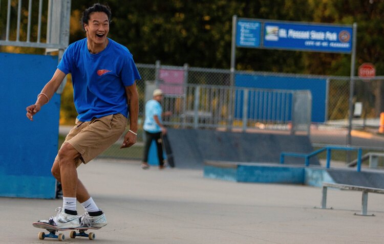 Carson Motz, 21, of Lansing, reacts to landing a trick while playing H.O.R.S.E. with friends at the Island Park skate park in Mt. Pleasant. “Parks like this keep kids out of the streets,” Motz said. “It’s a good place to practice and meet people."