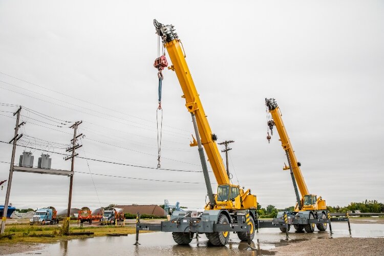 Workers at the port use three sets of cranes. One set offloads the ship. A second set helps attach the fixtures that secure the blades to the trucks. And a third set loads the trucks.