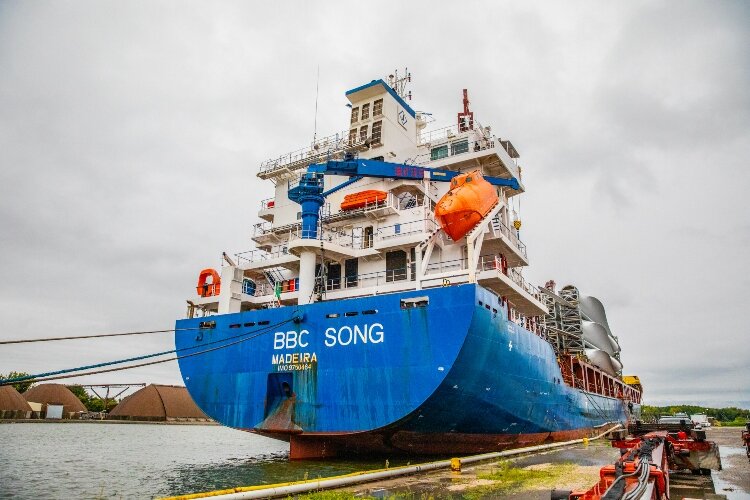 Freighters, including the BBC Song, spent more than a month at sea transporting the blades to the Saginaw River. Orange fixtures go on the trucks.