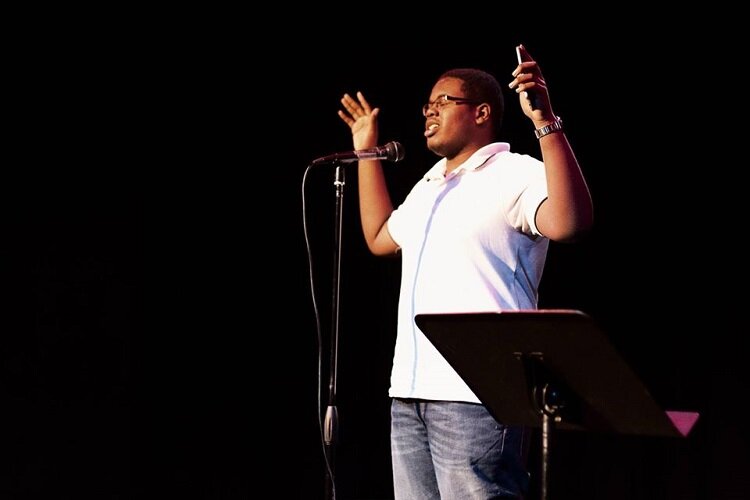 A Citywide Poets youth shares his words during a performance.