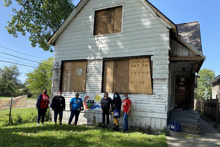 COC supporters gather in front of their new community center.