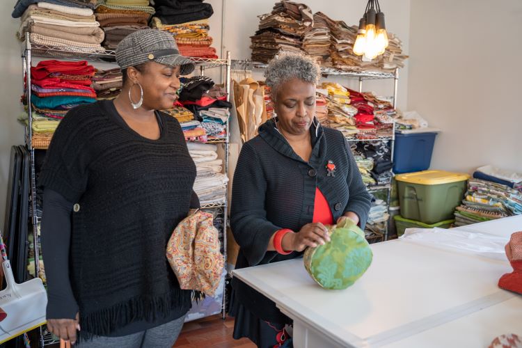 Stephanie Dickey speaks with shop employee Starr Lloyd.