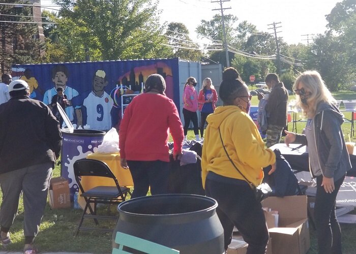 Community members meet outdoors during a MACC Development event.