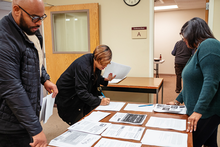 CDAD members browsing literature at a caucus meeting