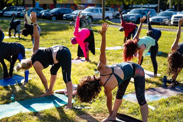 Participants practice yoga at Detroit's Palmer Park.
