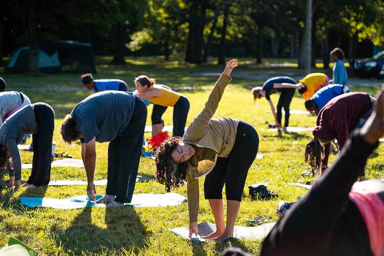 Participants practice yoga at Detroit's Palmer Park.