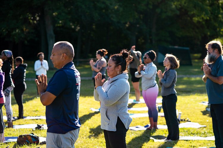 Participants practice yoga at Detroit's Palmer Park.