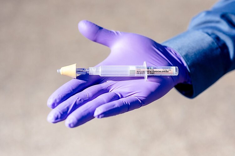 A syringe of naloxone,.