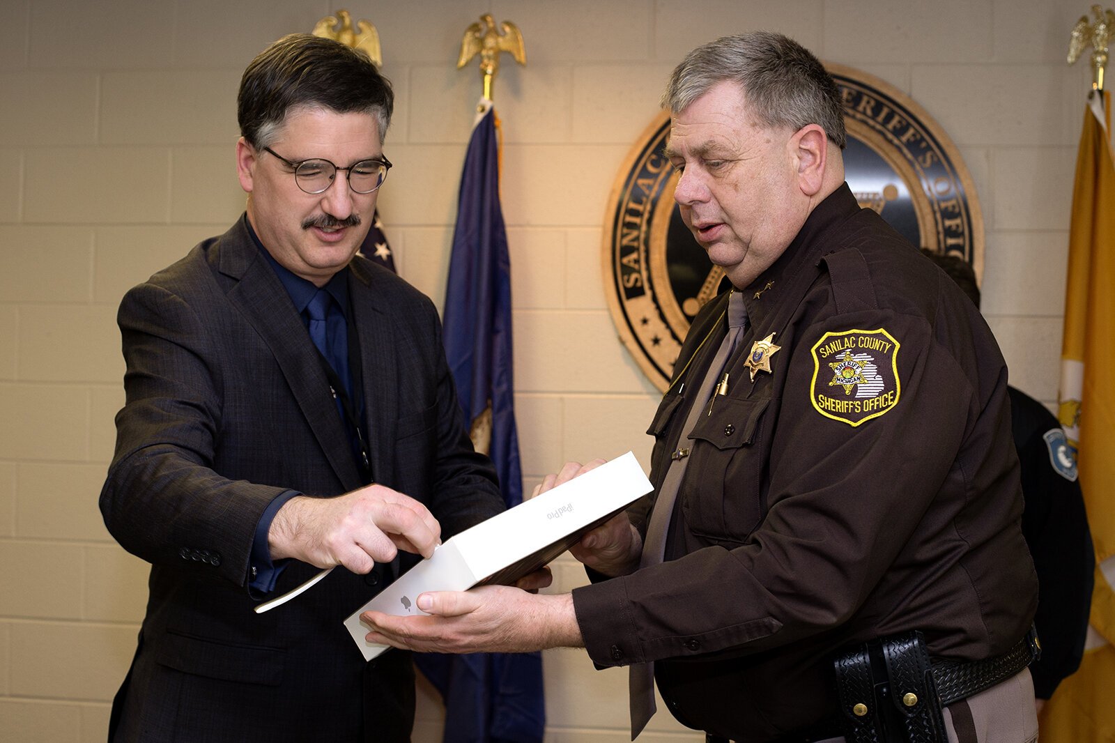 Sanilac County CMH CEO Wilbert Morris presents iPad to Sanilac County Sheriff Paul Rich
