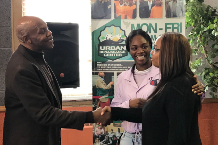 Claressa Shields (center) introduces Jasmine Burrell to Pastor Robert McCathern at Joy Tabernacle Church. Burrell will lead the Clarissa Shields Community Project. 