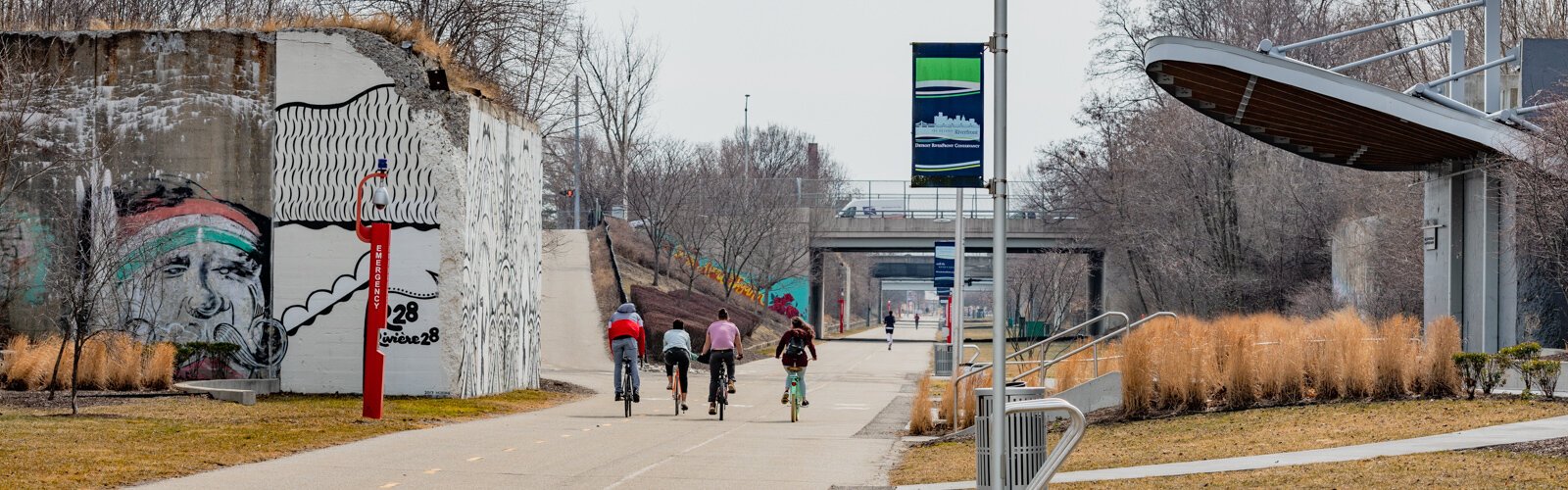 People biking along the Dequindre Cut in Detroit.