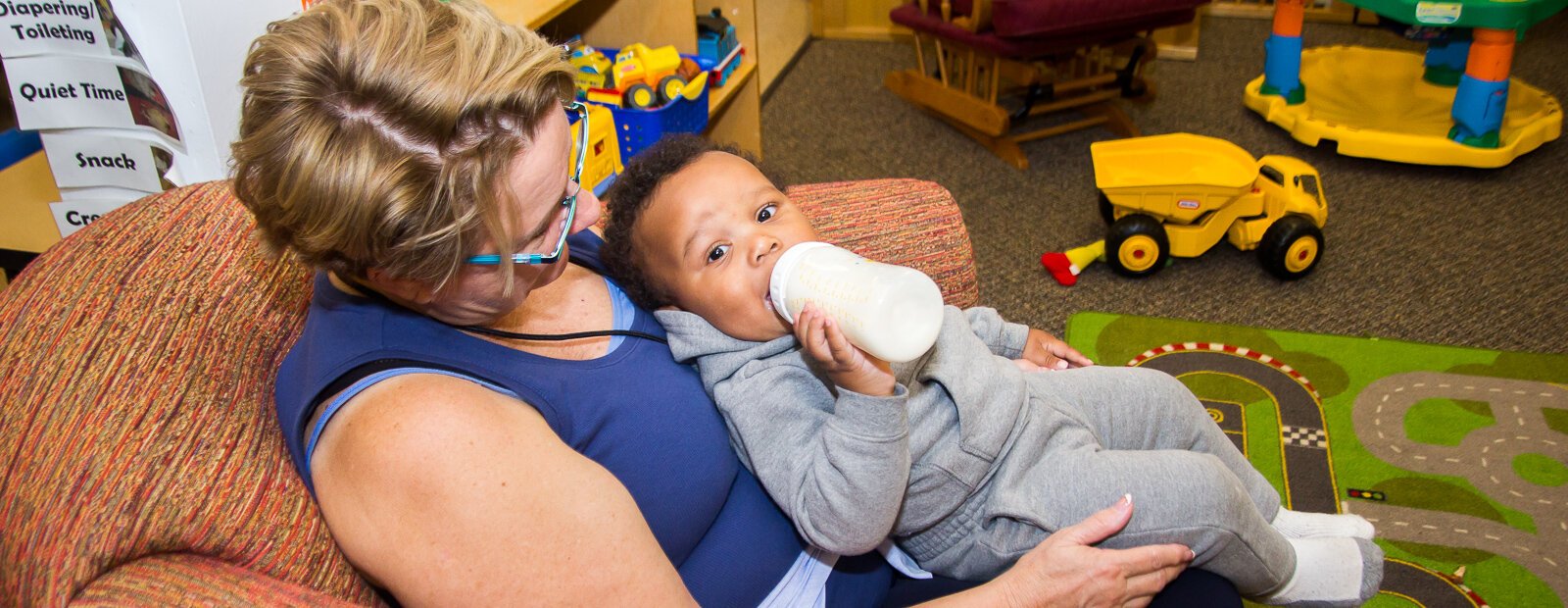 Volunteer Linda Thompson with a child at the Kalamazoo Drop-In Child Care Center.