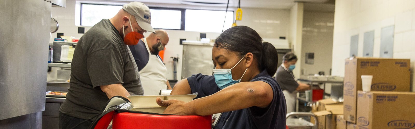 Patrick Tucker, Jon Garcia, and Shalina Jones prepare meals for delivery at Senior Services Southwest Michigan.