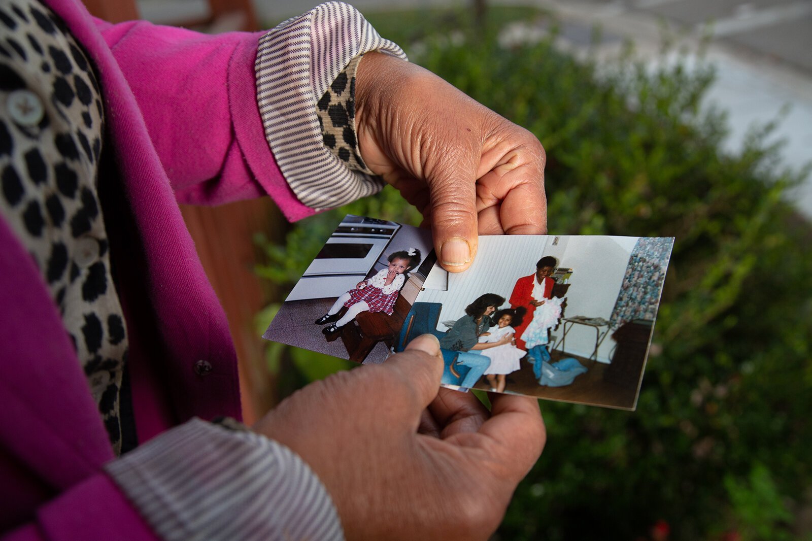 Yvonne Woodard holds a photo of her children.