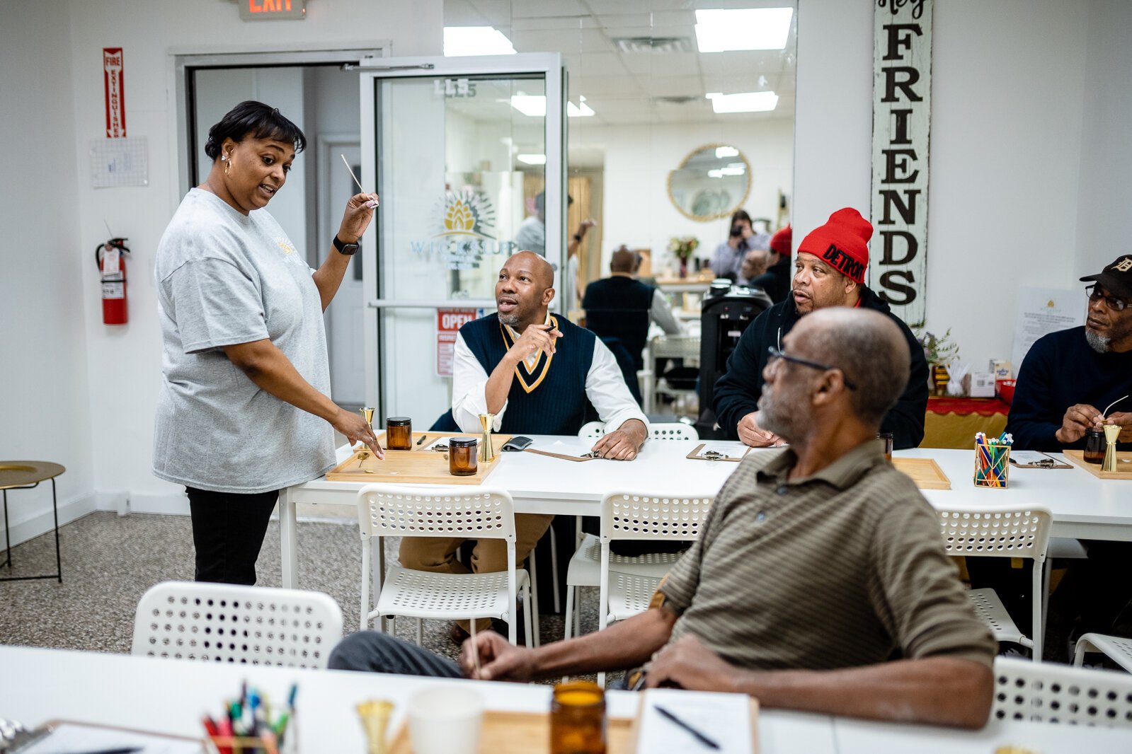 Aisha Sanders, owner and creator of Wicksup Candle Co. in Oak Park, explains the candle making process to a Food and Friendship Connections group.