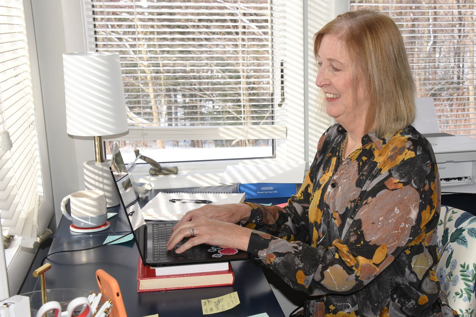 Jenifer Murray, a contracted grant coordinator with Munson Healthcare, works on programs for new parents in her office.