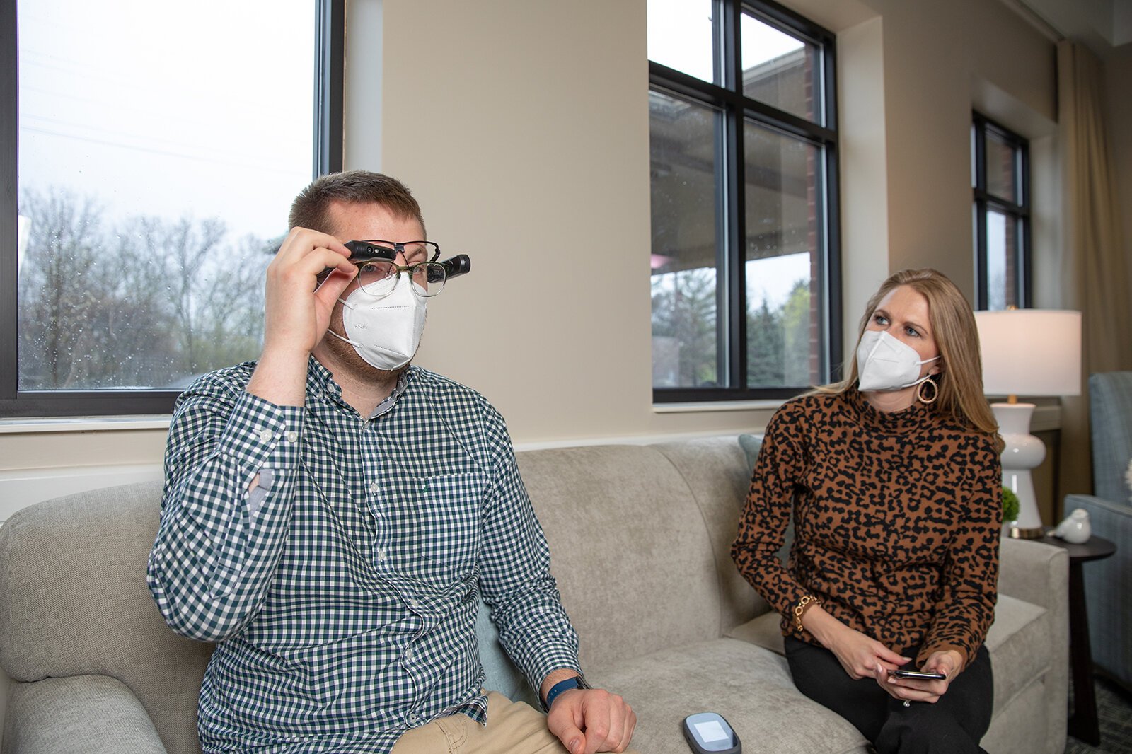 Dayna Roe, Samaritas director of memory care, demonstrates smart glasses with a colleague.