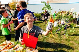 Students run a farm stand as part of Partridge Creek Farm's farm to school program in Ishpeming.