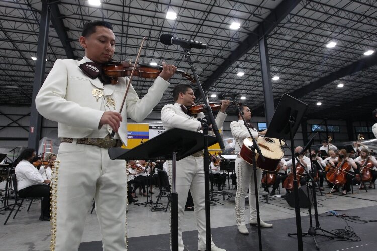 Mariachi Garibaldi de Jaime Cuéllar members Luis Zambrano, Jimmy Cuéllar and Albert Jimenez, of Los Angeles, California, perform the song “Guadalajara” at the Holland Symphony Orchestra’s “Mariachi & the Movies” community concert at M.E. Yacht Restor