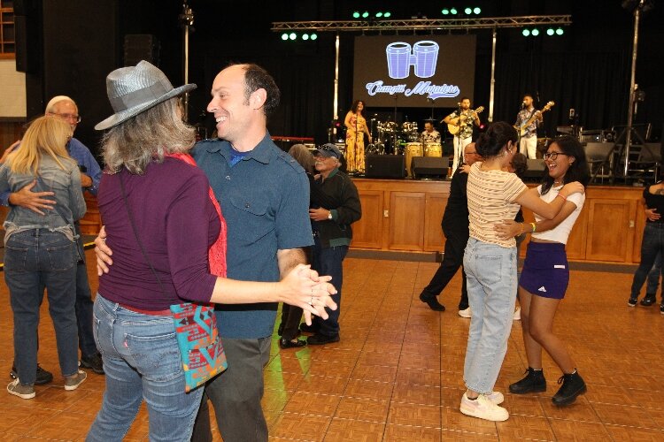 Mike Tuccini and Kathleen Schenck, of Holland, and visitors attending the International Festival of Holland dance to the Cuban roots music of Changüí Majadero, of Los Angeles, California, at the Holland Civic Center. (J.R. Valderas)