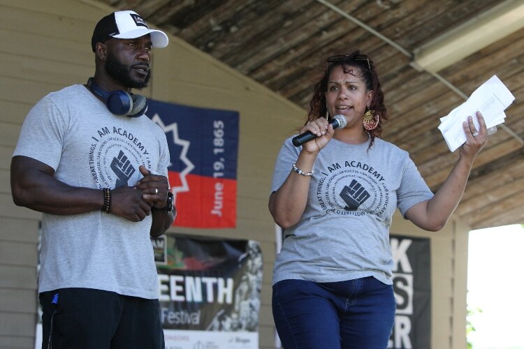I AM Academy's founders Lindsay Cherry, right, and Henry Cherry welcome everyone to the Juneteenth Freedom Festival at Kollen Park in Holland, Michigan, June 18, 2022.
