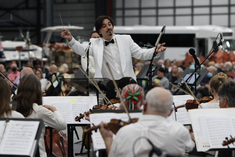 Mark Alpizar guest conducts the Holland Symphony Orchestra during their “Mariachi & the Movies” community concert at M.E. Yacht Restoration in Holland Township, August 13.