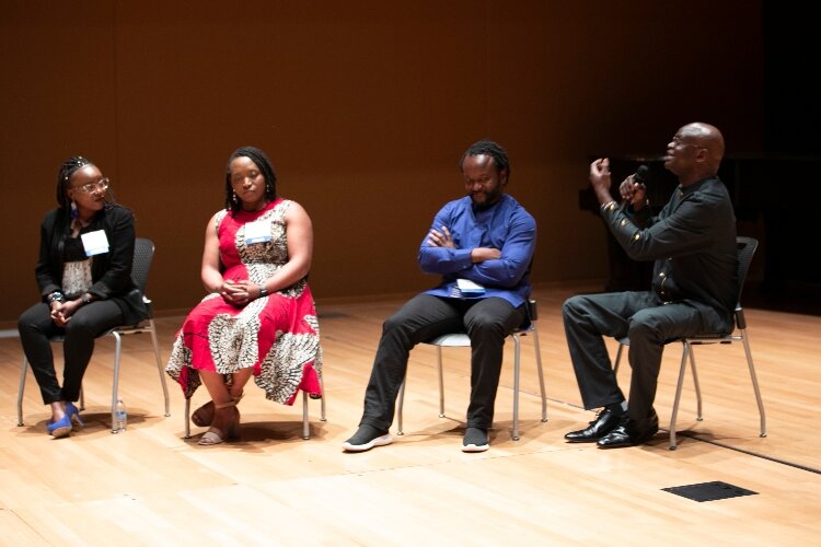 Gerald Baraza speaks during the session on Cultural Connections: Amplifying African Voices in West Michigan. He's joined by Christine Mwangi, Dr. Esai Umenei and Myra Umenei. (Hector Salazar)