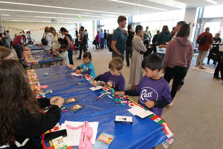 Youngsters create passports in the Passport Station section of the Children’s Fiesta during the International Festival of Holland at the Holland Civic Center. (J.R. Valderas)