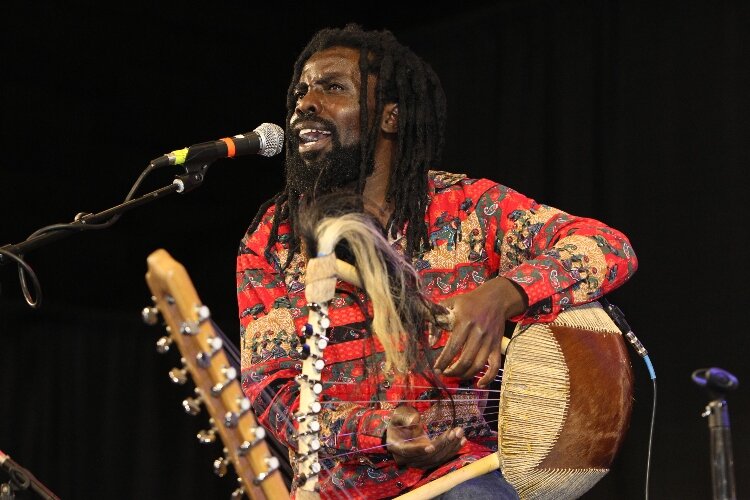 Samuel Nalangira, of Samuel Nalangira and The Crew from Kalamazoo, performs Ugandan music during the International Festival of Holland at the Holland Civic Center. (J.R. Valderas)