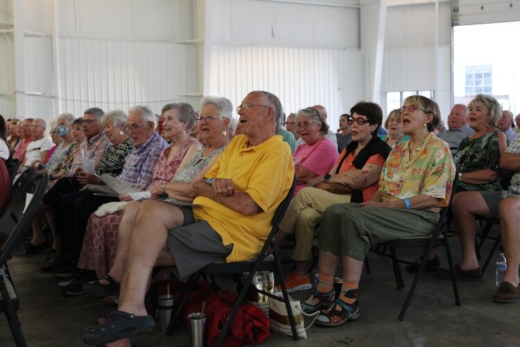 Members of the audience sing along with Bryron Stripling while attending the Holland Symphony Orchestra's "Pops at the Pier" concert at Eldean Shipyard in Macatawa, Michigan, June 16, 2022.