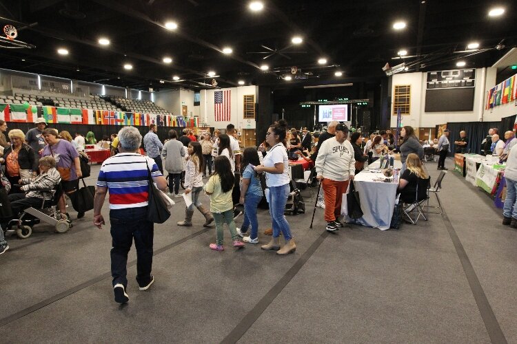 Visitors walk around the non-profit organization booths in the Holland Civic Center while attending the International Festival of Holland. (J.R. Valderas)