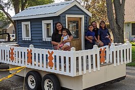 The Morales family rode on the Lakeshore Habitat parade float down Columbia Avenue to their new home at 132 E. 37th St., where an outdoor dedication was held.