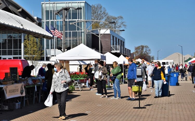 Pandemic restrictions thinned the typical crowds on the opening day of Holland Farmers Market.