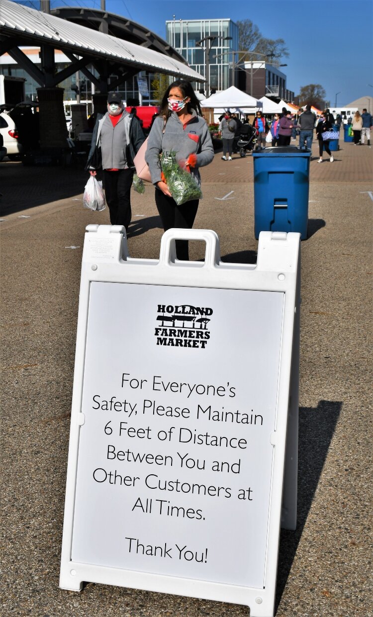 Signs remind shoppers about the operation of the market during a pandemic.
