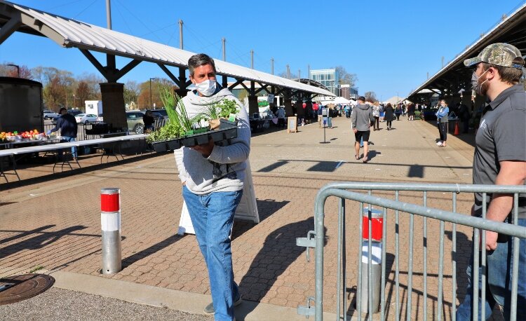 A perimeter fence limits access to the outdoor market on West Eighth Street.