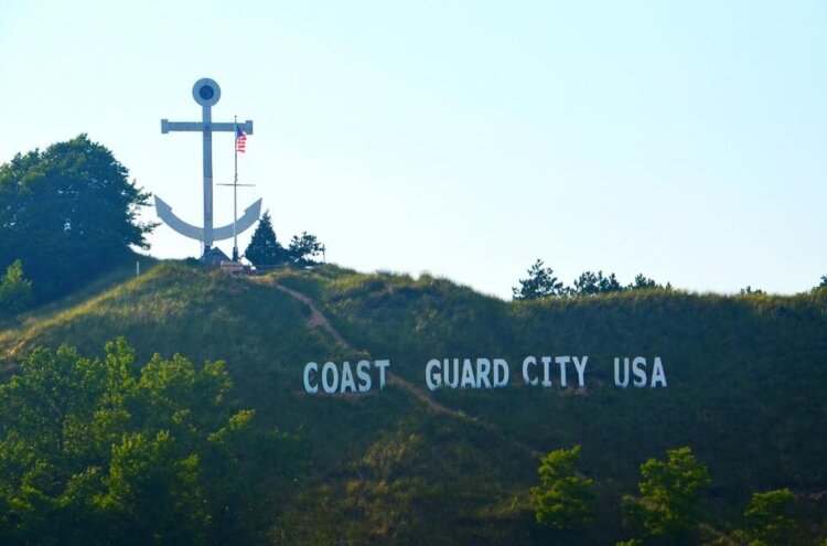Each year, the anchor and letters spelling out “Coast Guard City U.S.A.” are placed on Dewey Hill.
