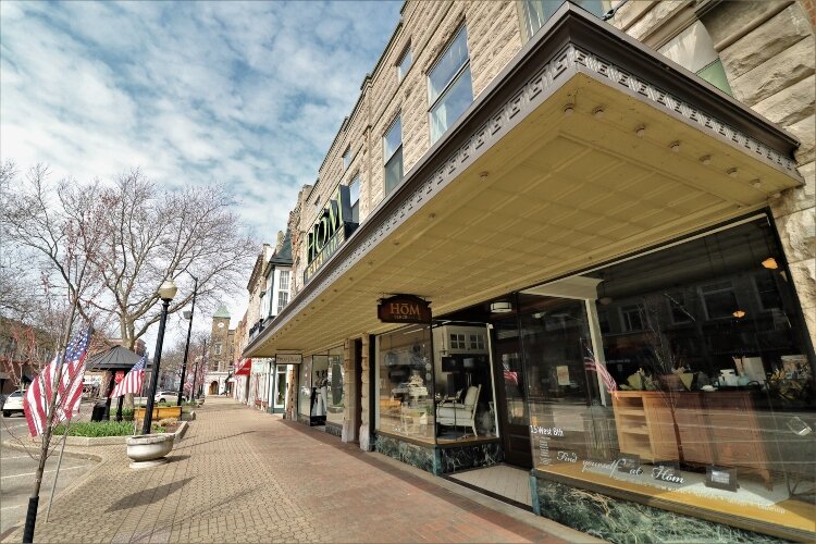 With shops and restaurants closed, the sidewalks in downtown Holland lack the usual hustle and bustle of a springtime Saturday.