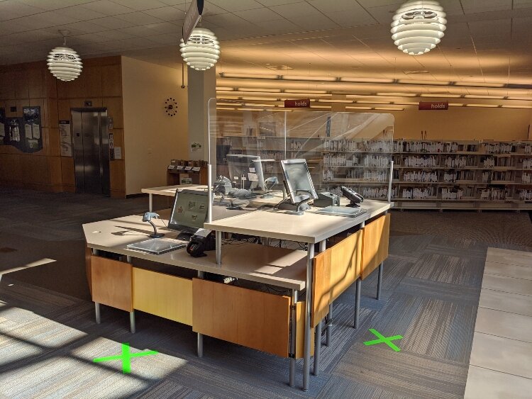 Barriers have been put up at Herrick District Library's checkout station.