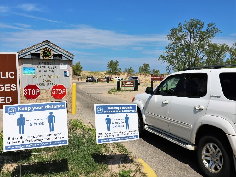 Coronavirus recommendations greet visitors to state parks in Holland and Grand Haven.