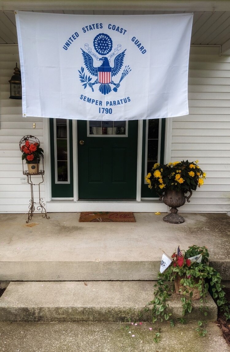The Moroney family is flying the Coast Guard flag in front of their Grand Haven home this year. 