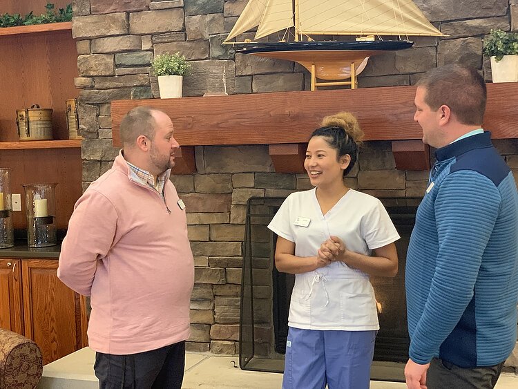 Karuna Khadka talks with Medilodge of Holland Director of Nursing Andrew Portko,  and Ryan Vanderstelt, Nursing Home Administrator. 